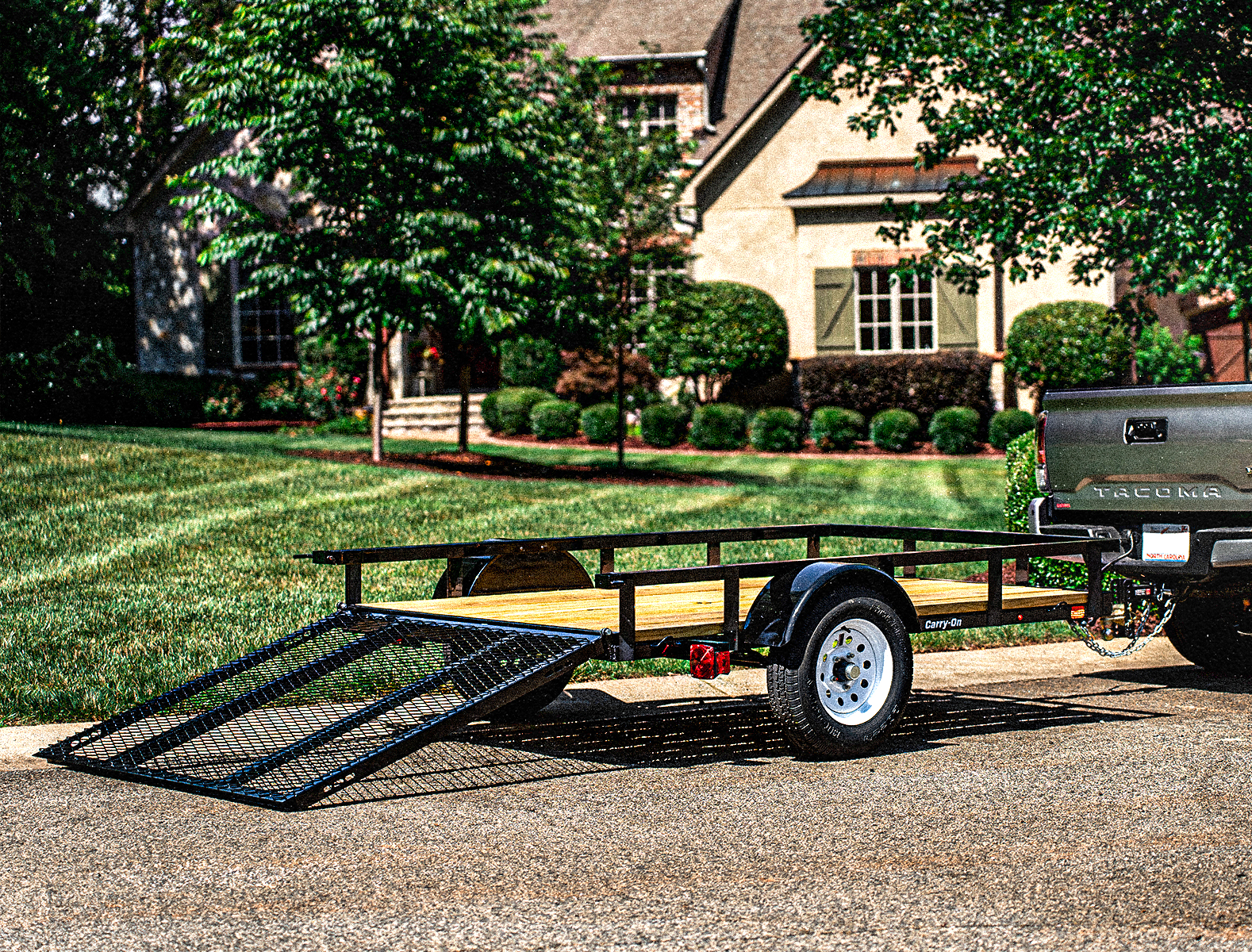 Wood floor utility trailer with gate down hitched to truck